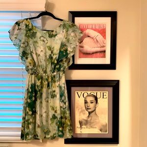 Green floral mini dress with ruffled sleeves.
